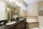 The en-suite bathroom features dual vanity, garden tub, and walk-in shower